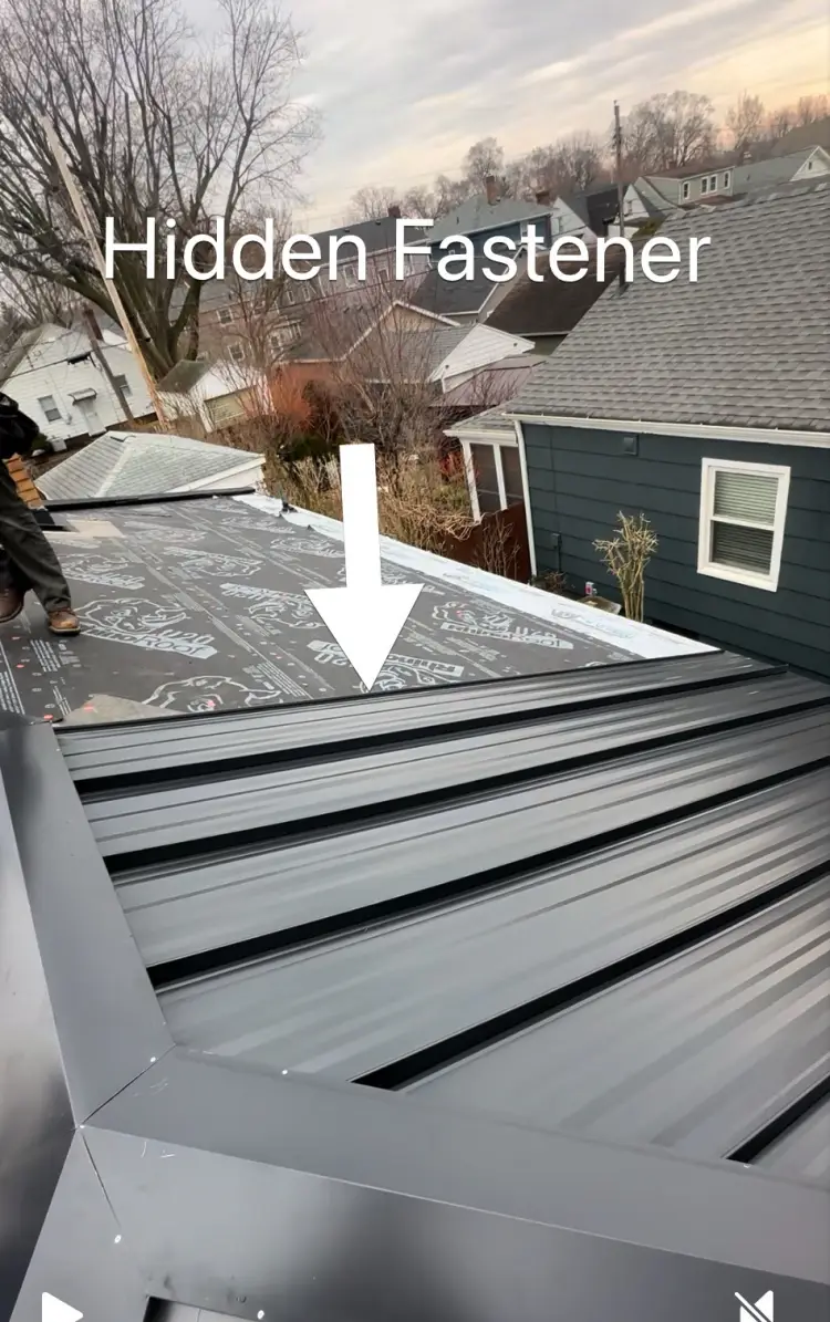 Green exposed fastener metal roof panels with the screw rows visible on the face of each panel